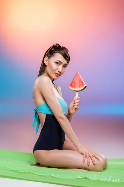 Girl in swimsuit eating watermelon — Free Stock Photo