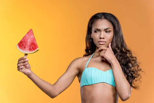 Pensive girl holding watermelon piece — Free Stock Photo