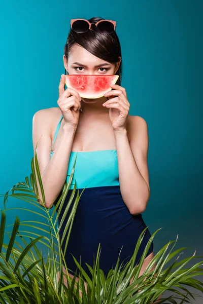 Woman in swimsuit holding watermelon piece — Stock Photo, Image