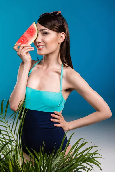 Asian girl in swimsuit holding watermelon — Free Stock Photo