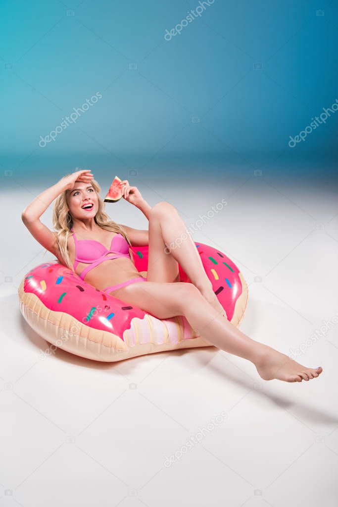 woman eating watermelon on float ring