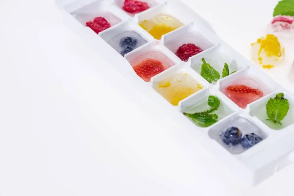 Ice cubes with berries — Stock Photo, Image