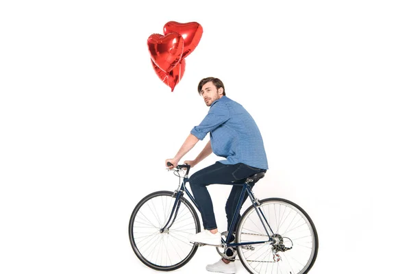 Man riding bicycle with balloons — Stock Photo, Image