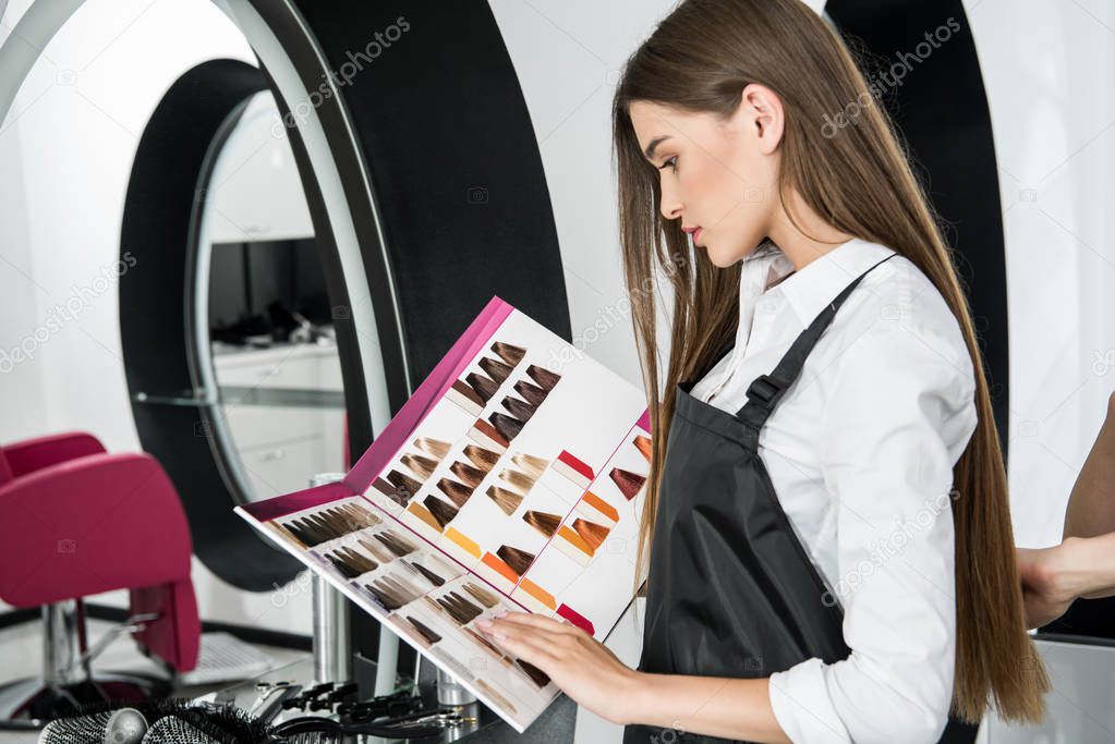 stylist looking at hair color samples
