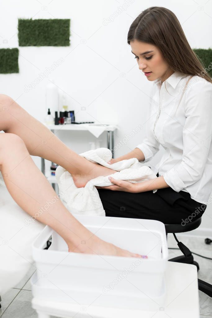 woman getting pedicure procedures