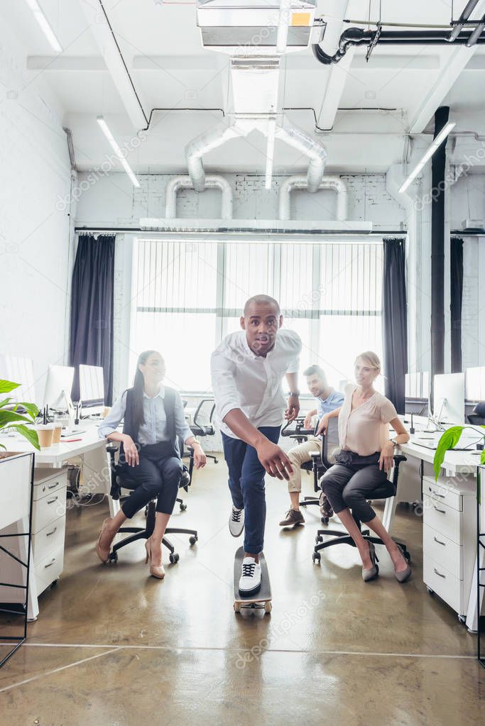 businessman on skateboard in office 