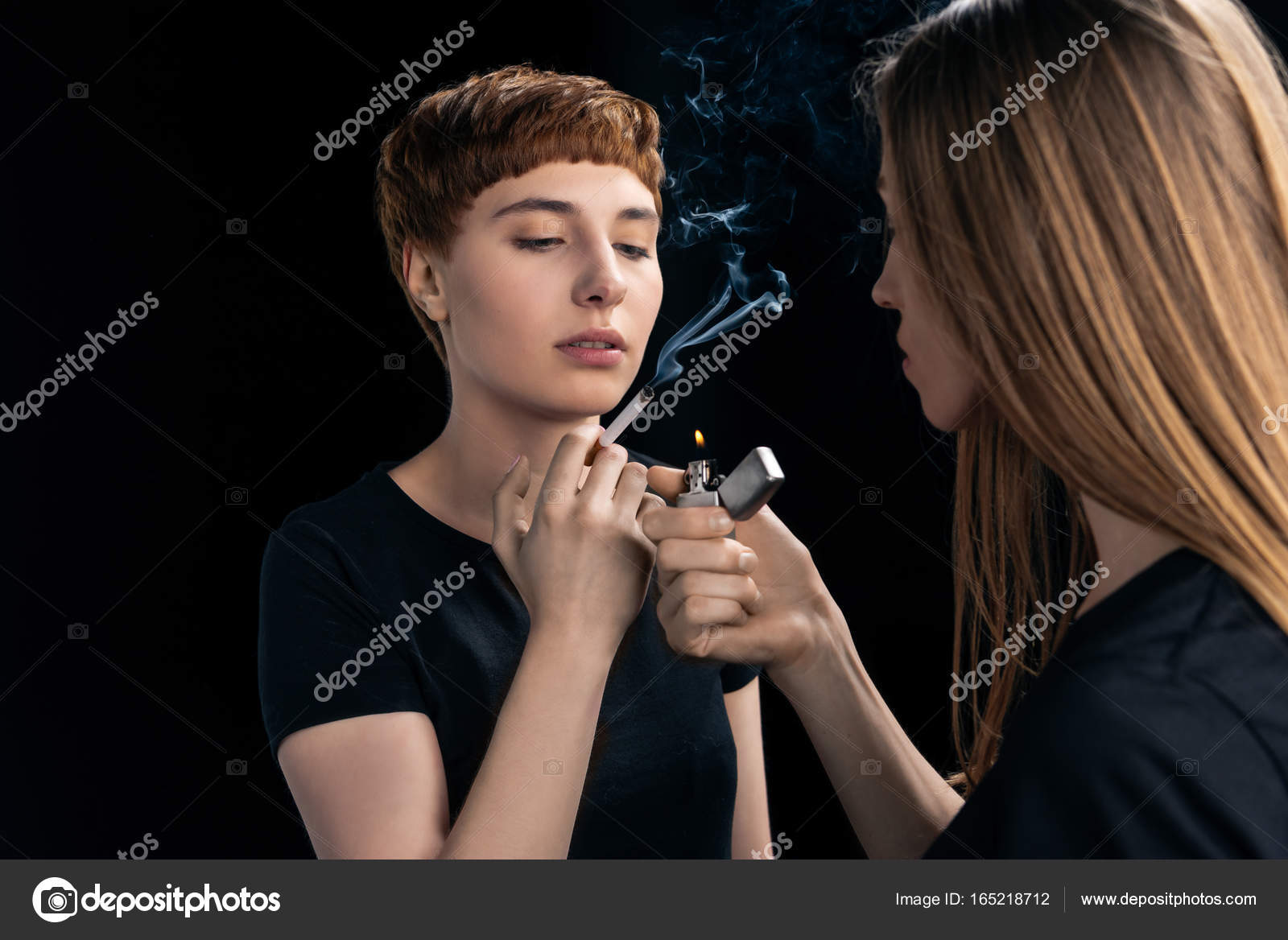Young woman lighting cigarette — Stock Photo © DimaBaranow 165218712