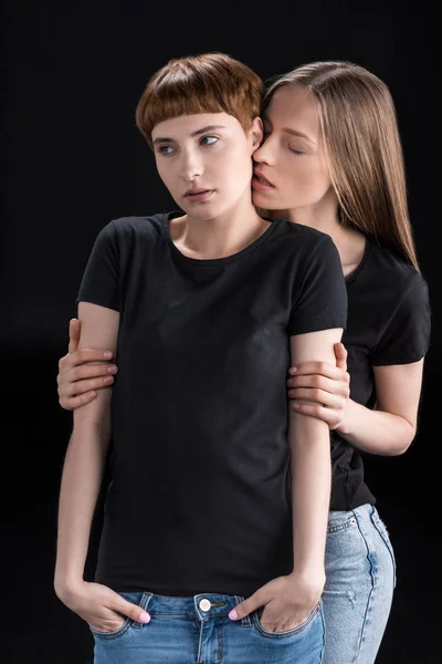 Young woman embracing girlfriend — Stock Photo, Image