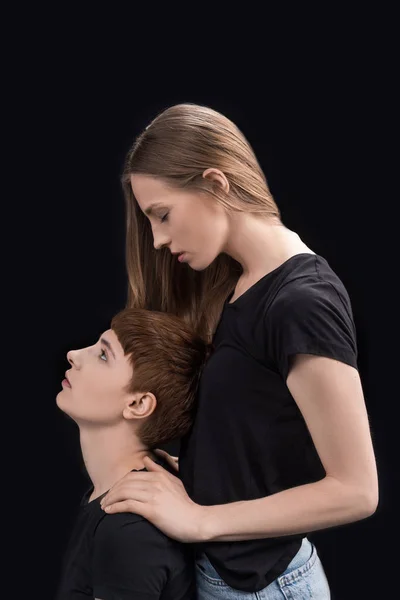 Woman holding shoulders of girlfriend