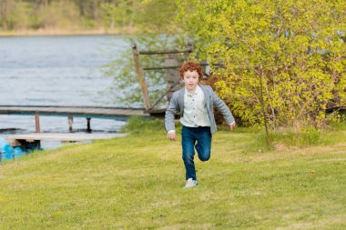 little boy running at countryside clipart