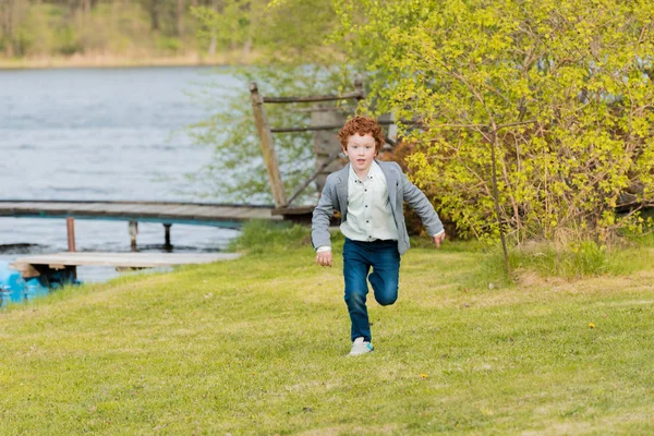 stock image little boy running at countryside