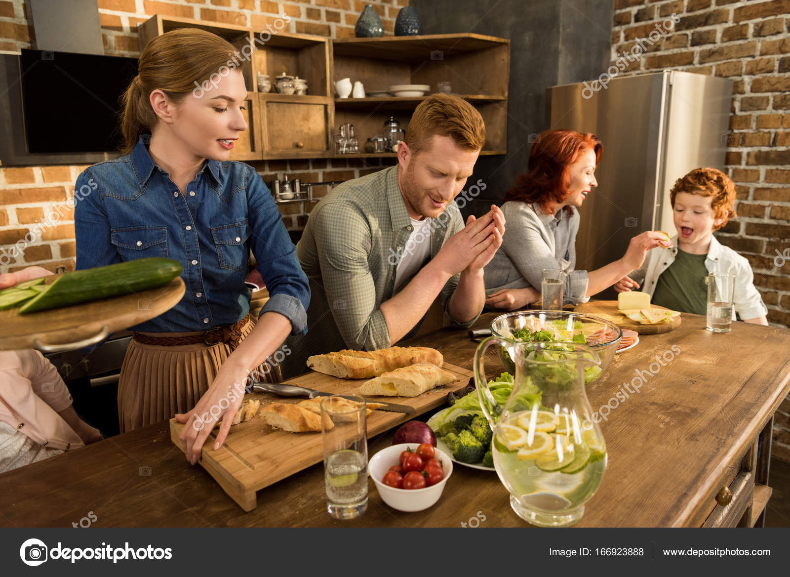 Family cooking dinner at home — Stock Photo © DimaBaranow #166923888