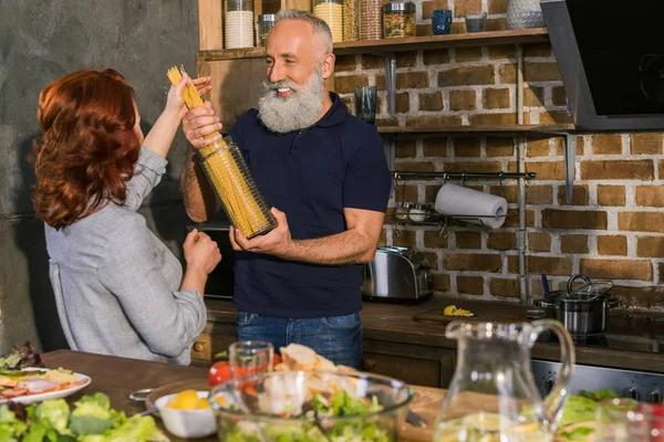 Senior couple cooking at home — Stock Photo, Image