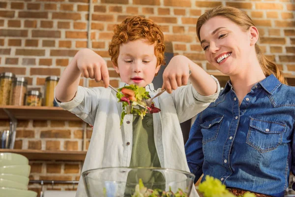 Hijo ayudando a madre a cocinar cena — Foto de Stock