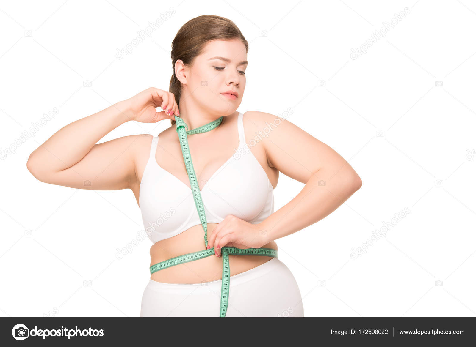 Woman measuring her waist size with a tape measure - StockFreedom - Premium  Stock Photography