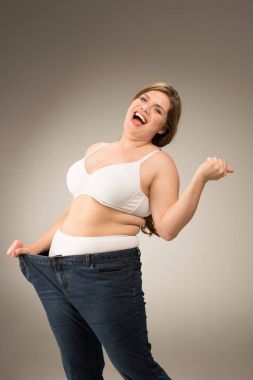 happy overweight woman in jeans clipart