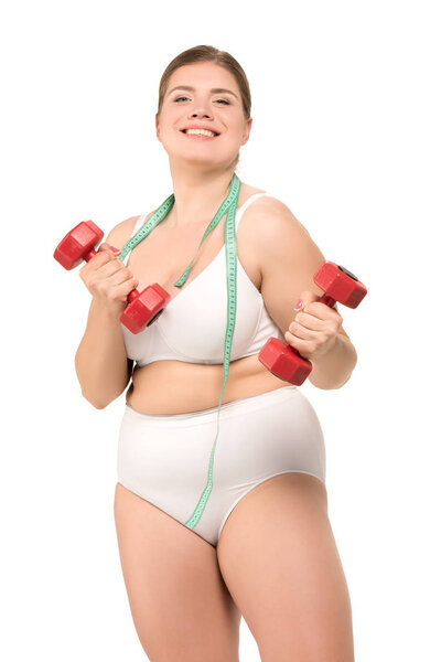 толстая женщина тренируется с гантелями
