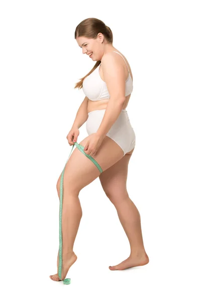 Overweight woman measuring leg — Stock Photo, Image