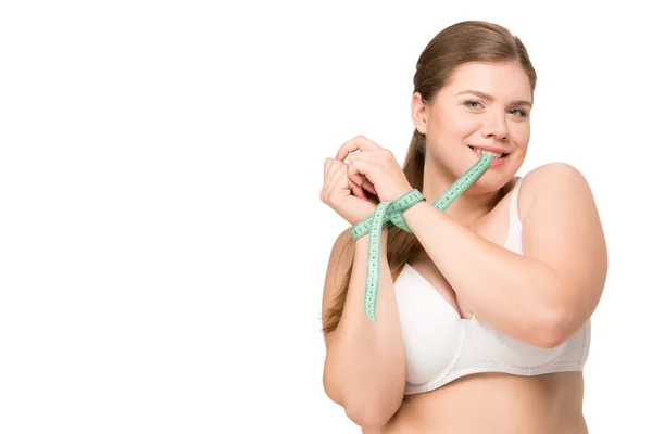 Overweight woman biting measuring tape — Stock Photo, Image