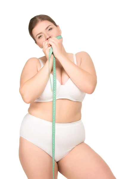 Толстая женщина с измерительной лентой — стоковое фото