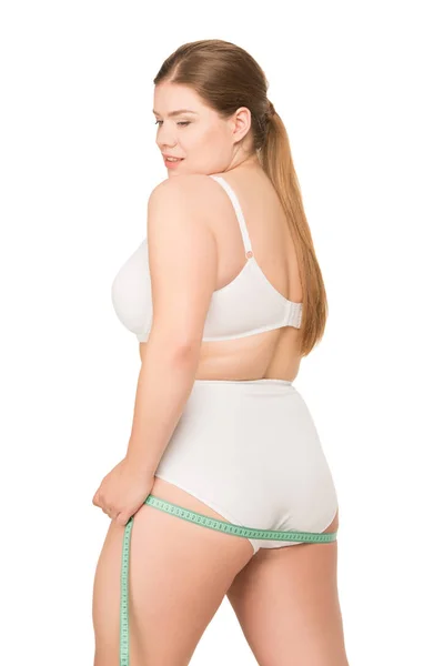 Overweight woman measuring butt — Stockfoto
