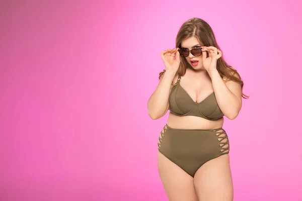 Übergewichtige Frau posiert mit Sonnenbrille Stockbild