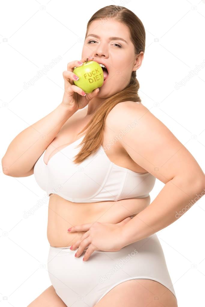 overweight woman eating apple 