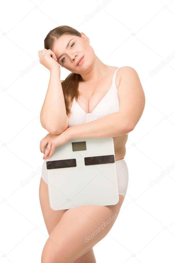 beautiful overweight woman with scales