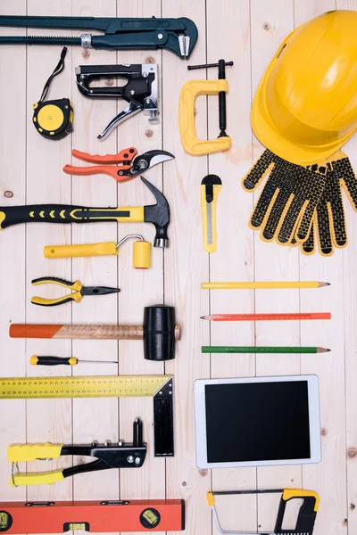 Top view of different tools with digital tablet on wooden tabletop — Stock Photo