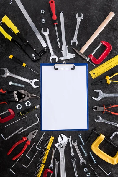 Top view of set of construction tools and blank clipboard — Stock Photo