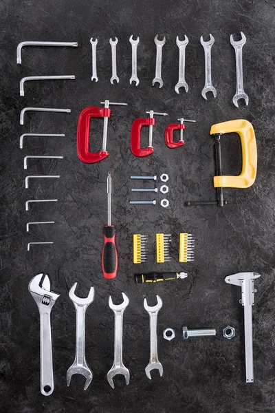 Top view of set of different construction tools on black — Stock Photo