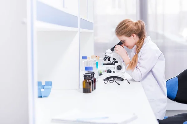 Little girl with microscope — Stock Photo