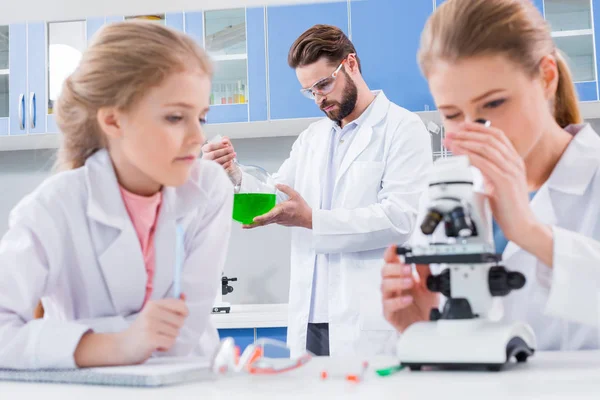 Teachers and student in lab — Stock Photo