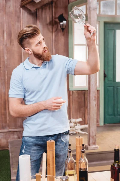 Young man holding glass — Stock Photo