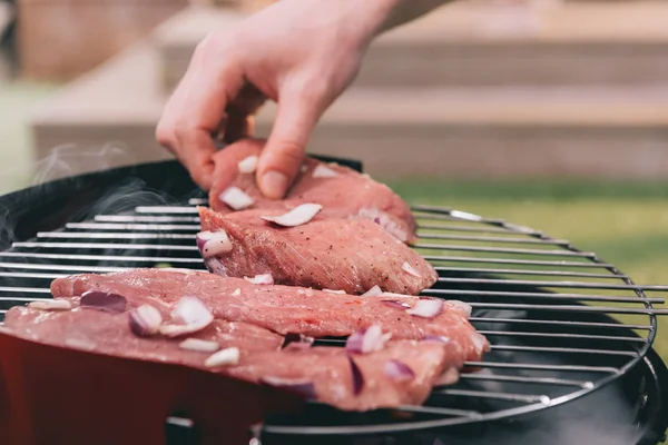 Man roasting meat — Stock Photo