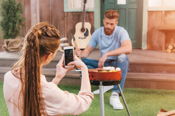 Woman taking photo of man — Stock Photo