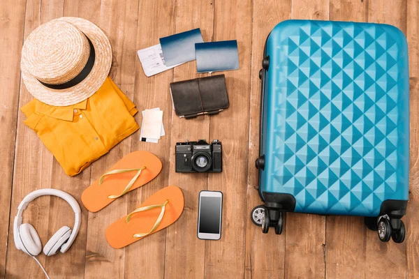 Travel accessories on wooden floor — Stock Photo