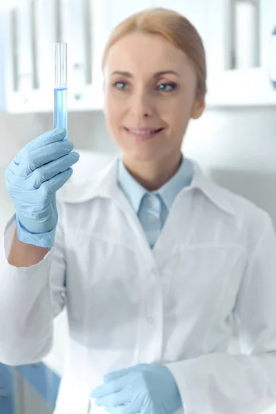 Chemist working with microscope — Stock Photo