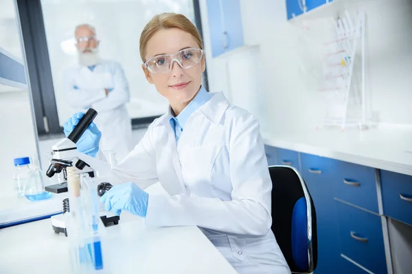 Scientist working with microscope — Stock Photo