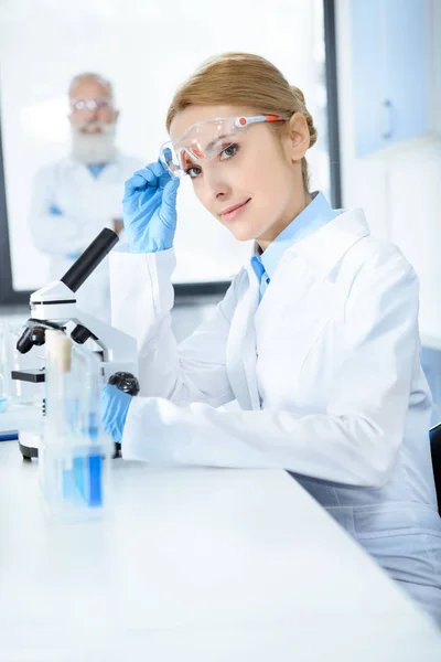 Scientist working with microscope — Stock Photo