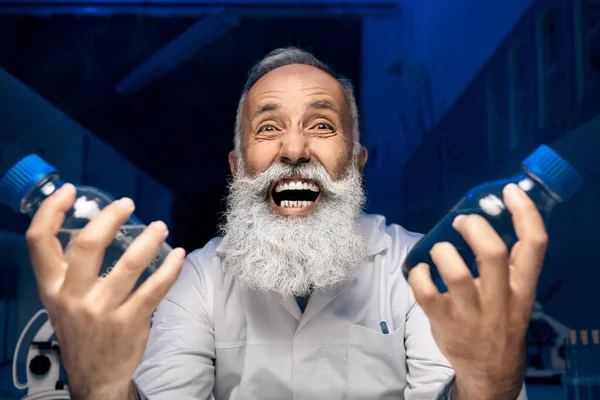 Scientist holding bottles with reagents — Stock Photo