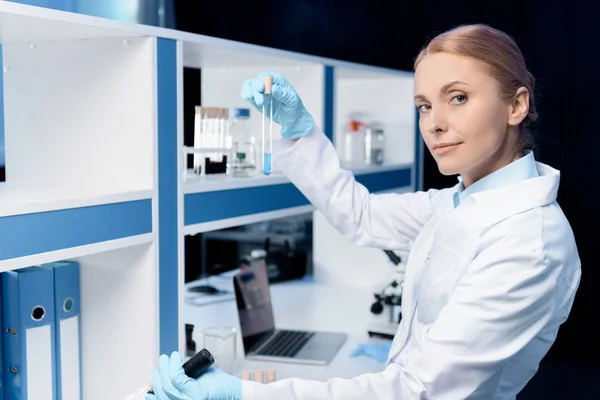 Scientist holding flask with reagent — Stock Photo