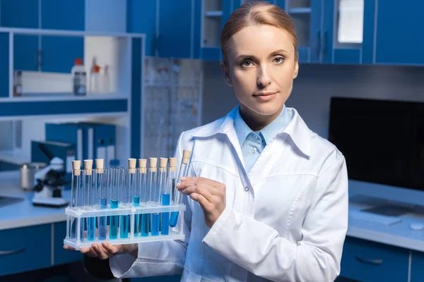 Cientista segurando tubos com reagentes — Fotografia de Stock