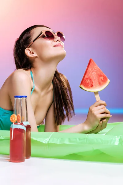 Girl in sunglasses sunbathing on swimming mattress — Stock Photo