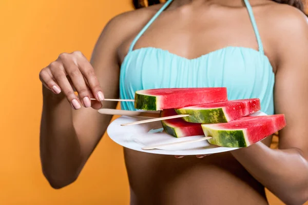 Woman holding plate with watermelon slices — Stock Photo