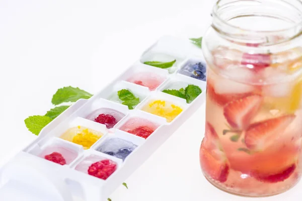 Berries in ice cubes — Stock Photo