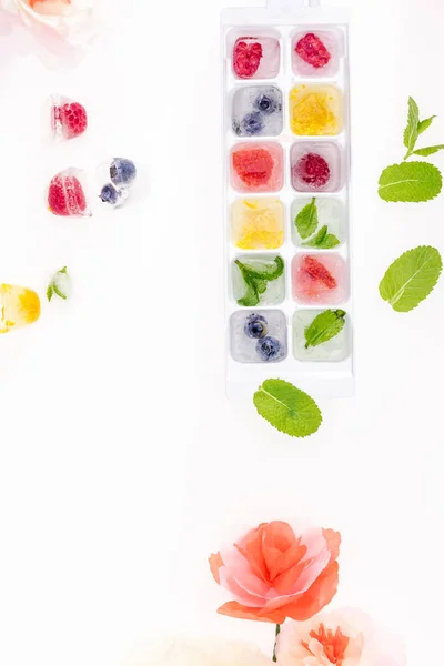 Berries in ice cubes — Stock Photo