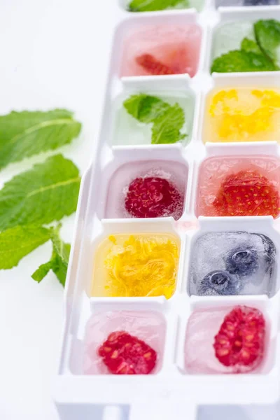 Berries in ice cubes — Stock Photo