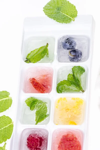 Ice cubes with berries — Stock Photo