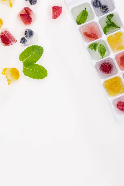 Ice cubes with berries — Stock Photo